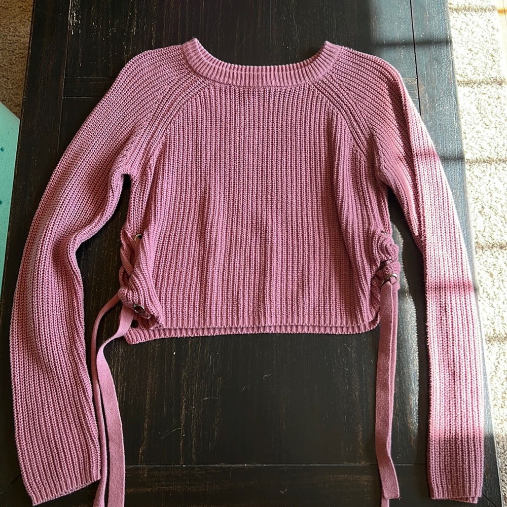 Pink cropped sweater with lace up sides